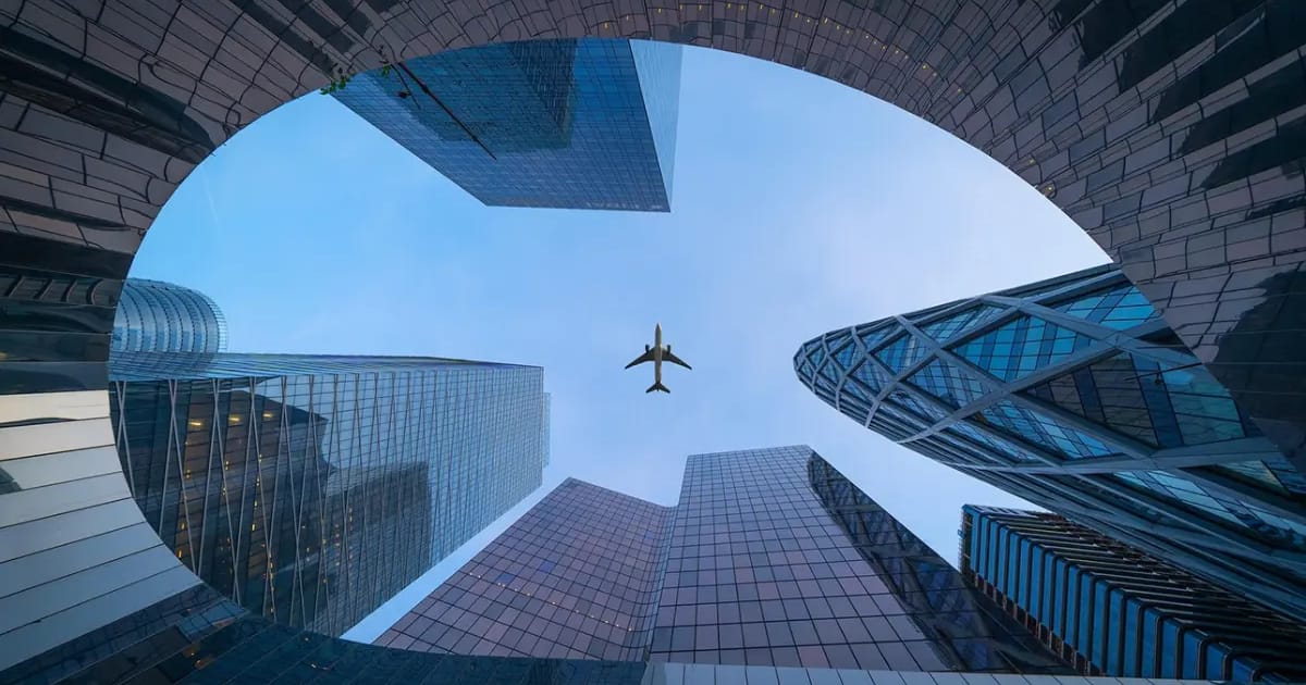 International city skyline with airplane representing immigration consultants in Kerala