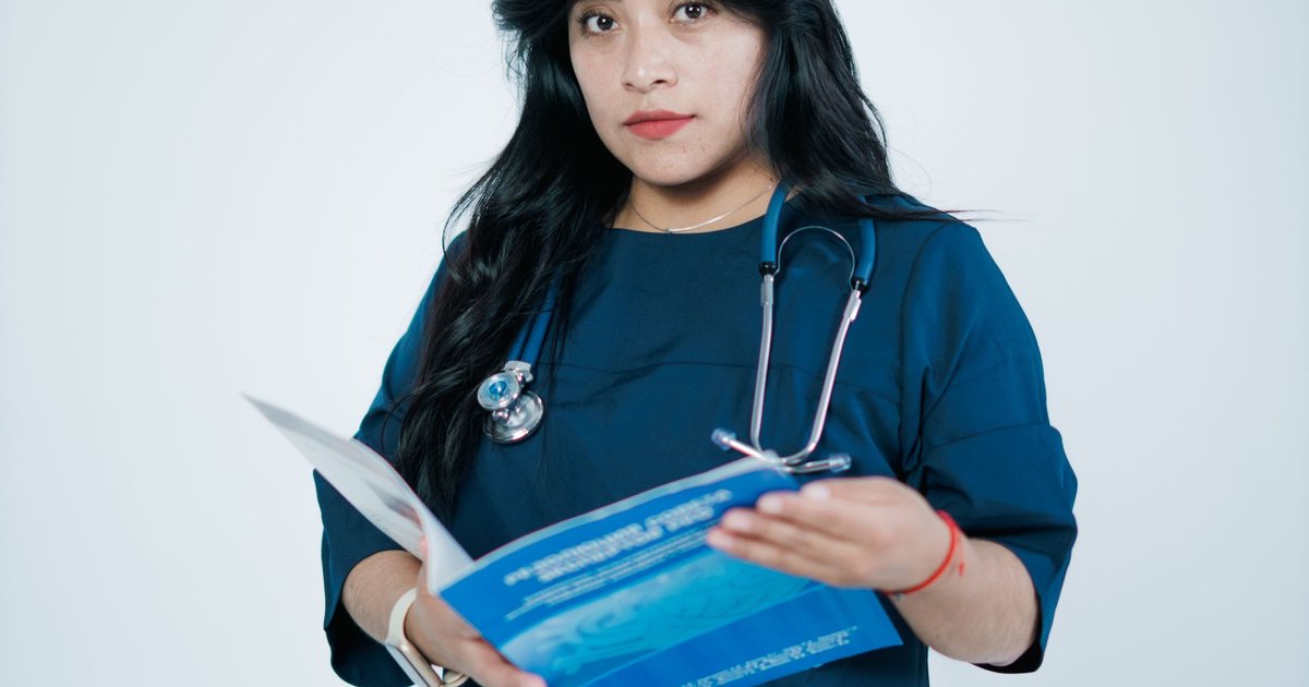 Nursing graduate in scrubs in an Australian hospital representing master of nursing in Australia