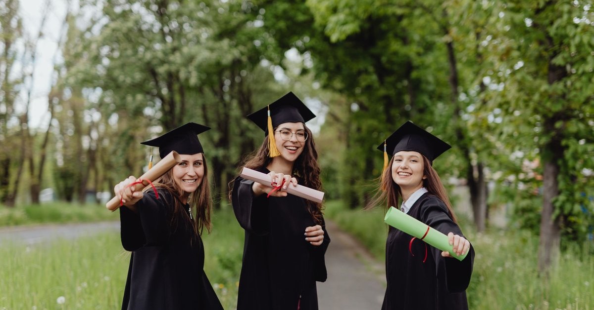 International graduates holding diplomas after finishing study that can earn professional year points and Australian study points